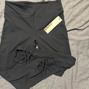 Brand new. Never worn. Black leggings with detail at bottom